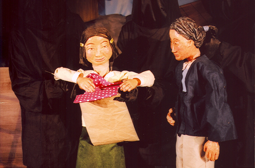 Photo of puppets, Momma and Tsuki opening the package.